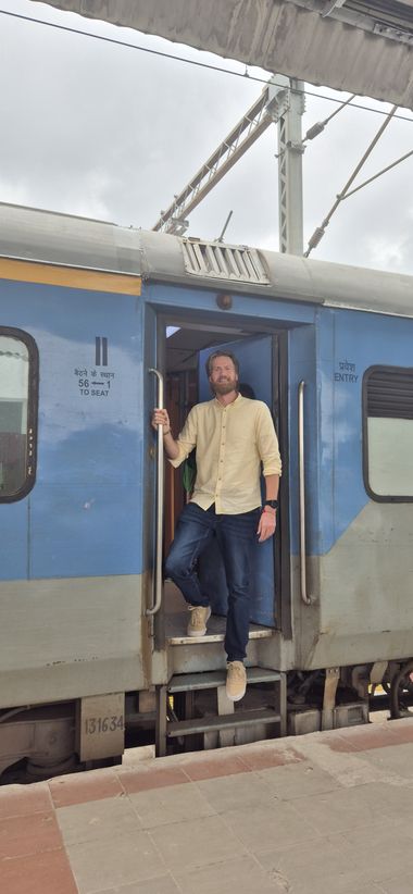 Diederik in the open doorway of an Indian train