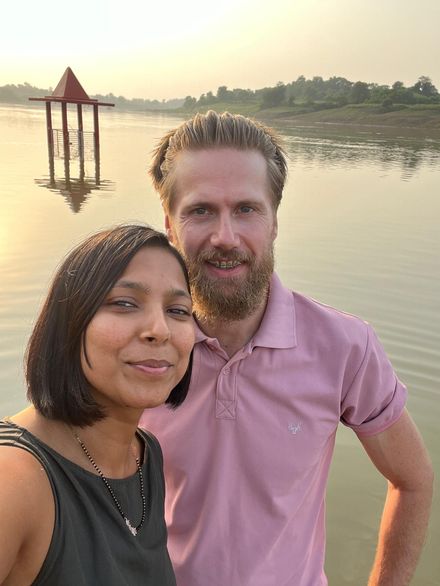 Yasha and Diederik at sunset on the Narmada, with a small temple standing in the water behind them